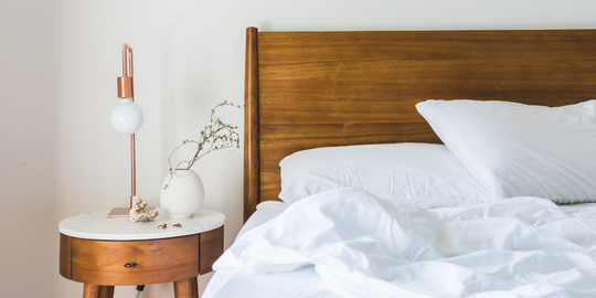 Clean minimalist bed with bright white bedding