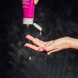 YES VM vaginal moisturiser is being squeezed from a tube onto a womans hand. 